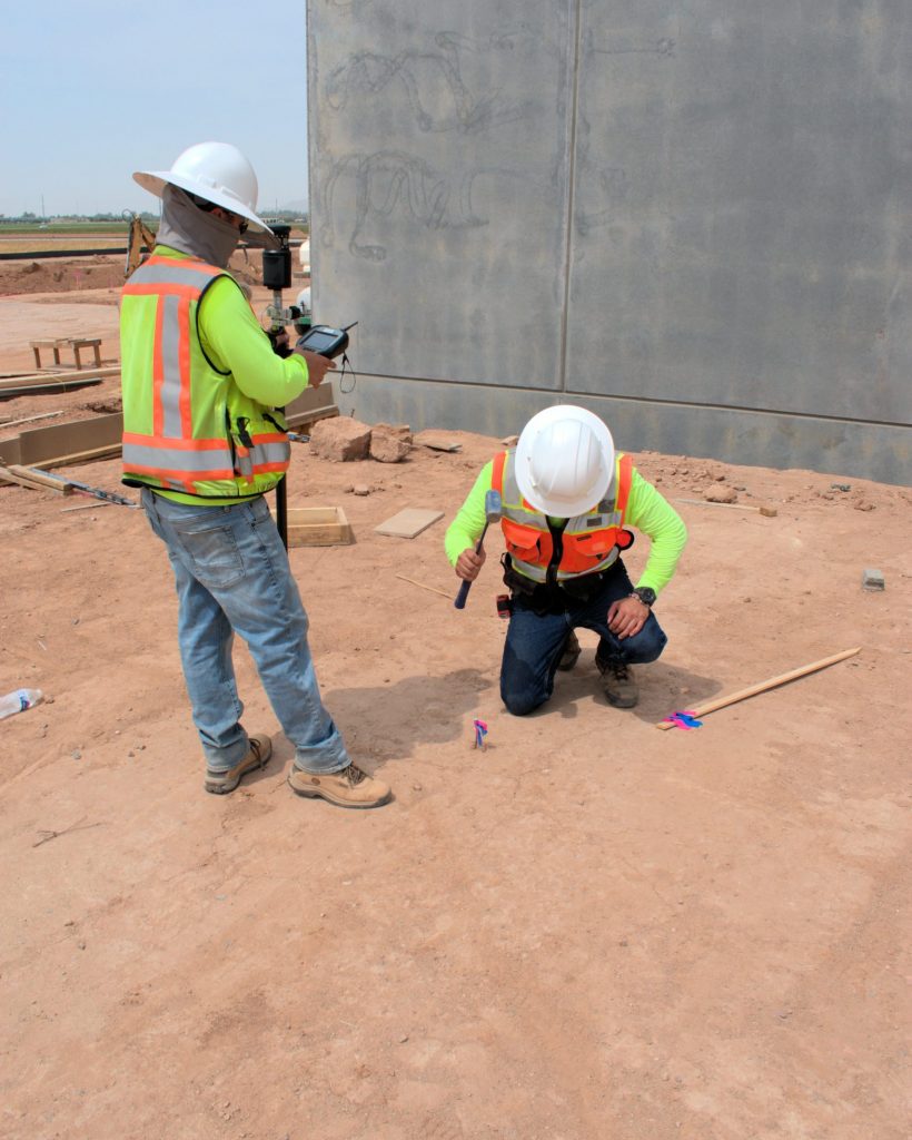 A Team Professional Associates field surveyors preparing stakes for wet utility layout during construction staking operations in Arizona. Photo by Jackson Kern.